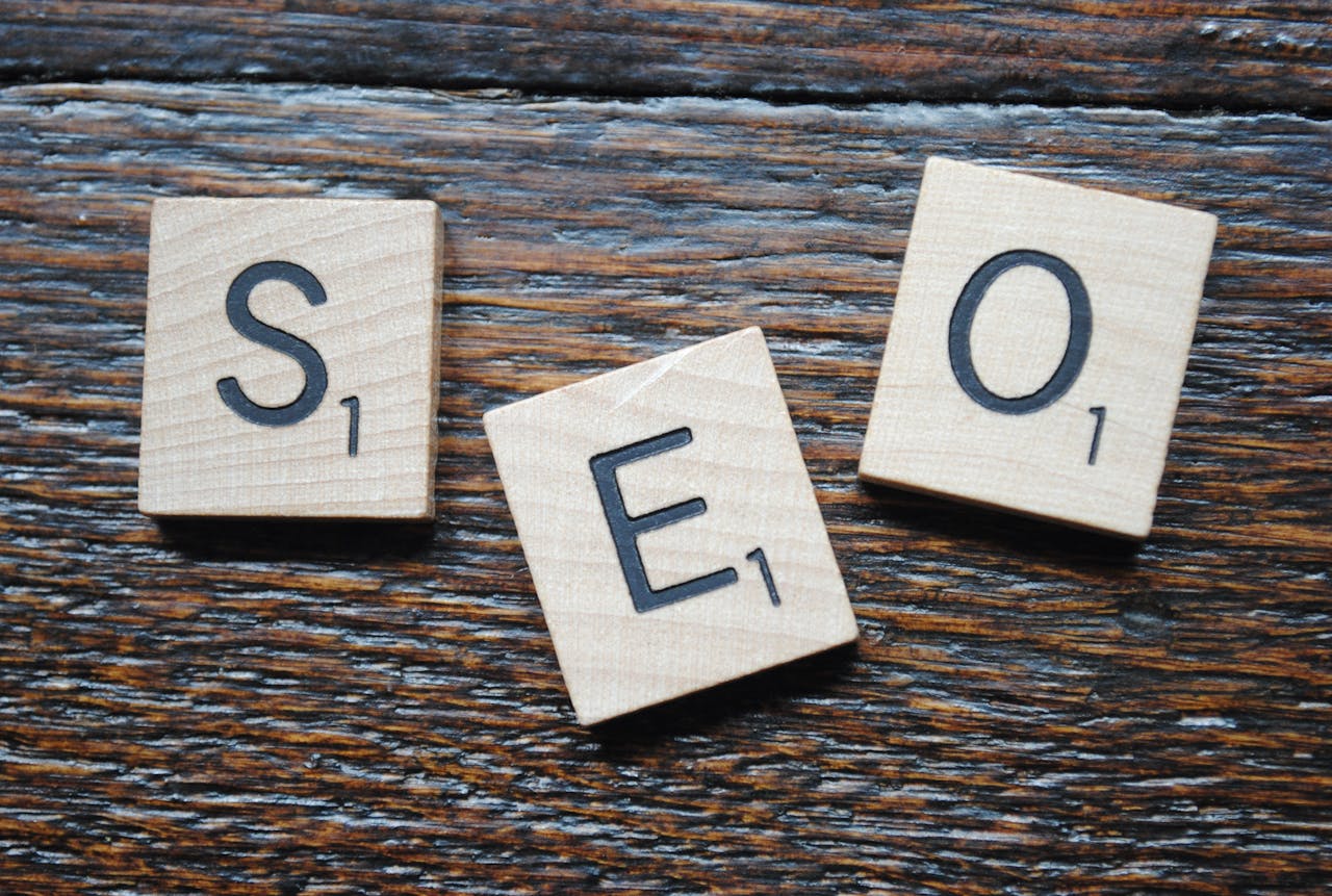 services-02 Close-up of Scrabble tiles spelling SEO on a wooden table for content strategy.