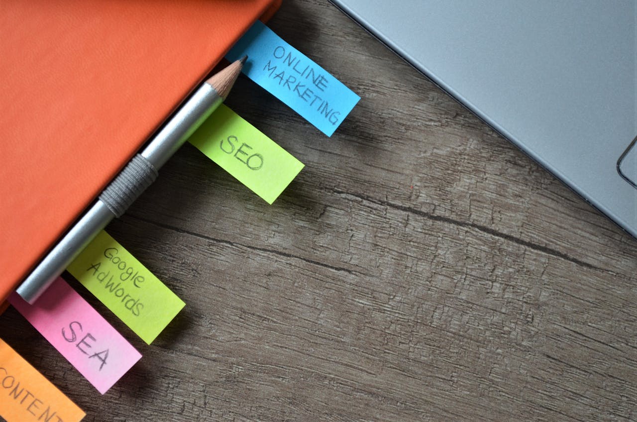 services-01 Close-up of SEO strategy planner with colorful sticky notes and a pencil on a notebook.